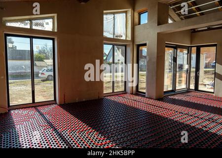 fllor heating in the house under construction with windows and light Stock Photo