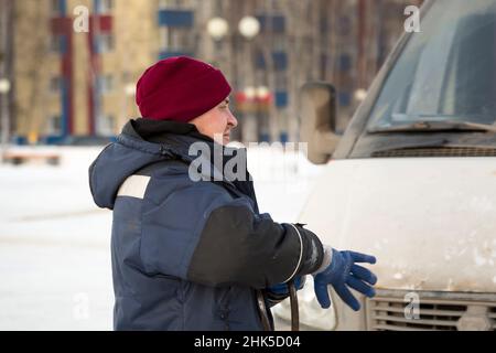 Portrait of a man in a blue winter jacket at the workplace Stock Photo