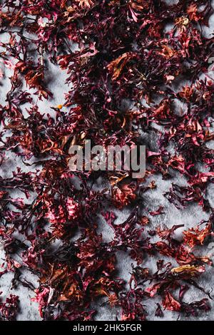 high angle view of some dried irish moss leaves on gray stone surface Stock Photo