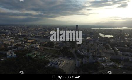 Beautiful and amazing view over the town. You can see the streets, the houses, the big skyscraper, the sun's rays burst through the clouds. Stock Photo