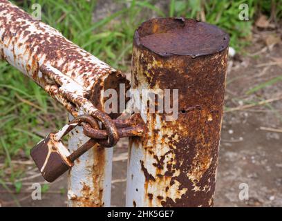 Rusty padlock hanging in the street alley Stock Photo