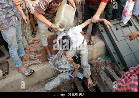 Dhaka, Bangladesh - February 02, 2022: While snatching a woman's mobile phone and fleeing, the public grabbed her and beat her up at Badda in Dhaka. Stock Photo