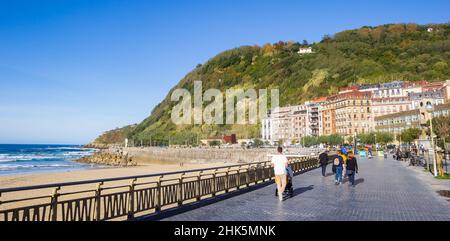 Panorama of people walking the promenade at the Zurriola beach in San Sebastian, Spain Stock Photo