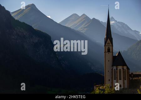 The parish church in Heiligenblut with the Grossglockner in the background Stock Photo