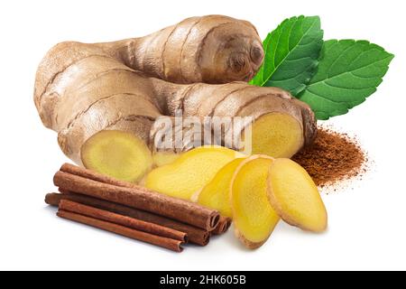 Giner root next to pile of cinnamon sticks, rama tulsi leaves and ground cinnamon isolated Stock Photo