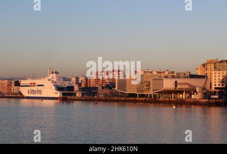 New Brittany Ferries ship the Salamanca moored with the Botin Arts Centre and the 'Stone crane' on a calm winter morning Winter Stock Photo