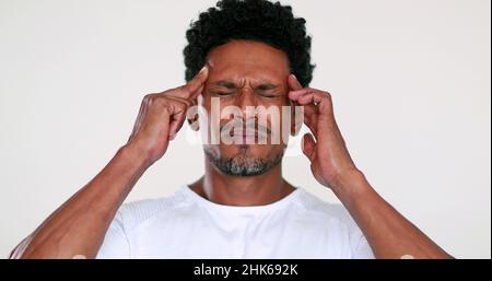 Person having a headache. Black man feeling pain and worry Stock Photo