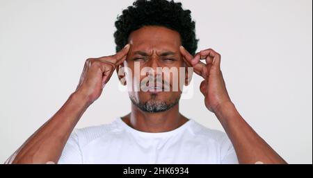Person having a headache. Black man feeling pain and worry Stock Photo