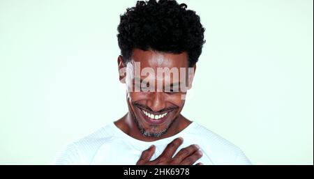 Portrait African man feeling grateful and thankful smiling to camera Stock Photo