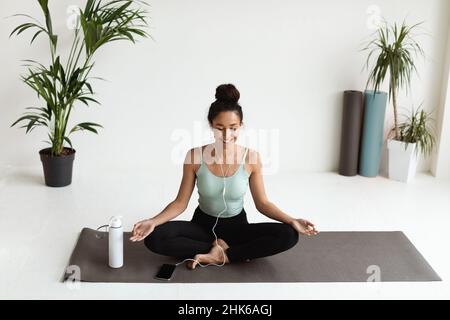 Portrait Of Relaxed Young Woman Listening Music And Meditating With Closed Eyes Stock Photo