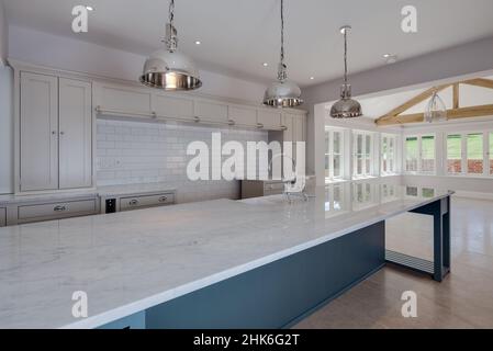 Sible Hedingham, Essex - May 10 2017: Kitchen area in period style within refitted and restored 16th century home with range of units and peninsula Stock Photo