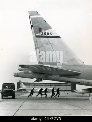 1959- US Air Force Strategic Air Command (SAC) crews run from their jeeps to board combat-ready aircraft on a training mission. SAC was established in March 1946 with a primary mission of Soviet 'deterrence.' Stock Photo
