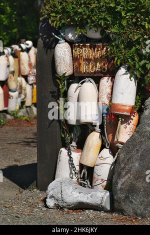 Lobster Floats Decorate a Private Road Sign in Tofino on Vancouver Island in Canada Stock Photo