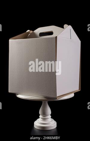 White paper box for cake with blank side and handle, isolated on black. Stock Photo