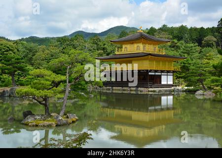 Japan, Kyoto - Golden Pavilion Kinkakuji or Rokuonji in a nice light and with mirroring on the lake in front surrounded by trees Stock Photo