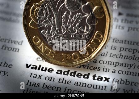 DICTIONARY DEFINITION OF WORD VALUE ADDED TAX WITH ONE POUND COIN RE VALUE ADDED TAX INFLATION COST OF LIVING VAT ETC UK Stock Photo