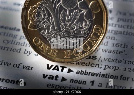 DICTIONARY DEFINITION OF WORD VAT WITH ONE POUND COIN RE VALUE ADDED TAX INFLATION COST OF LIVING ETC UK Stock Photo