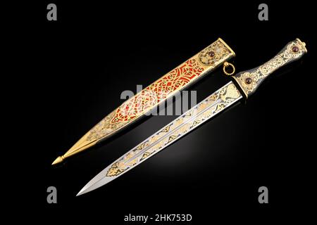 souvenir collectible silver gold dagger with scabbard on black. Luxury ...