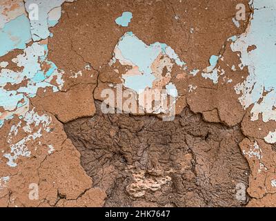 Textured plaster background. Terracotta brown with blue lime. Stock Photo