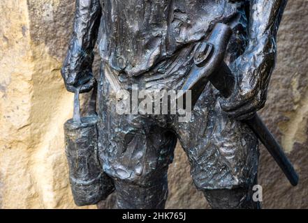 Doncaster January 2022: Artist/sculptor Laurence Edwards was commissioned to design the artwork witch now stands in the center of town Laurence  met with local people from the mining community, while they told their stories he sculptured their portraits in wax, these have then been cast in bronze and are now an important of the rock faces. The main statue a 6ft bronze miner stood in between the two rock faces, symbolising travelling up the mineshaft after a shift. Clifford Norton Alamy Stock Photo