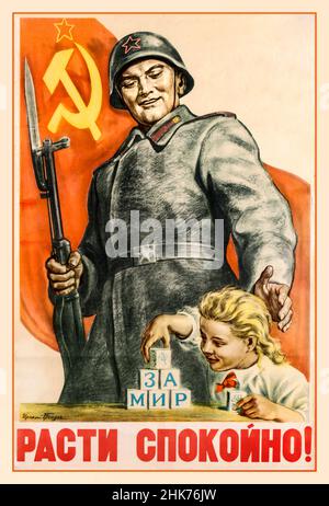 Vintage WW2 1940s Soviet Russian propaganda poster: '' Grow up peacefully!'up peacefully!' featuring a smiling young girl playing with building blocks spelling out To Peace below a brick with the image of a flower on it, watched over by an armed soldier in uniform protecting her in front of a large red flag with the USSR hammer and sickle emblem on it flying in the background, the text below in stylised red letters.Soviet Russian USSR Propaganda Poster Stock Photo