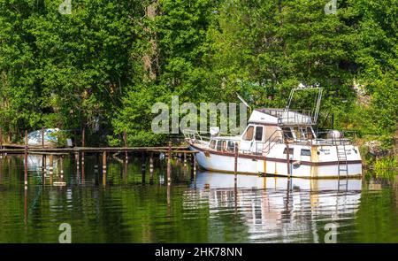 Rusty old motor yacht on the banks of the Havel in Spandau, Berlin, Germany Stock Photo