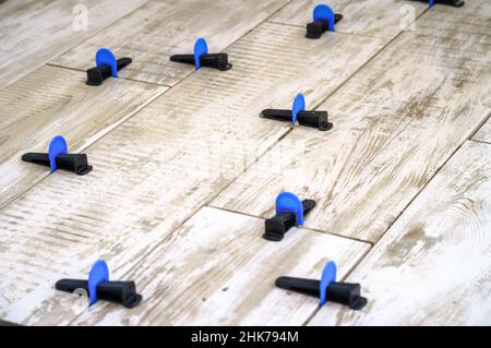Apparatus for laying stoneware tiles. Leveling system for installing ceramic tiles.. Stock Photo