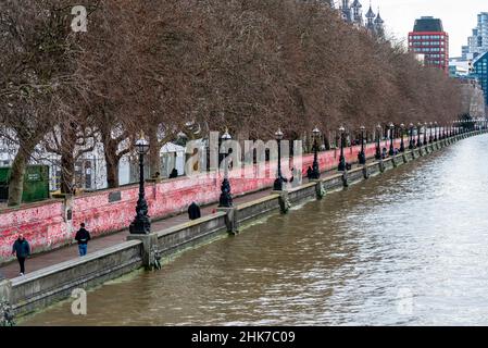 National Covid Memorial Wall on a grim overcast day in Lambeth, London, UK. Red hearts drawn onto a wall representing each death from COVID 19