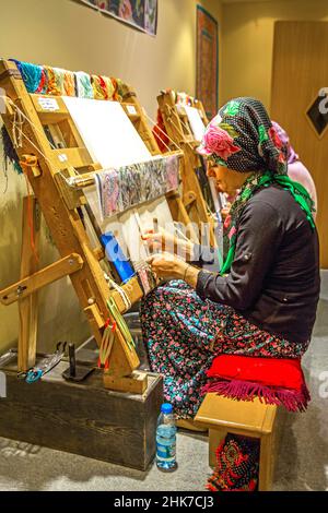 Woman at the loom, carpet manufactory, Cappadocia, Turkey, Cappadocia, Turkey Stock Photo