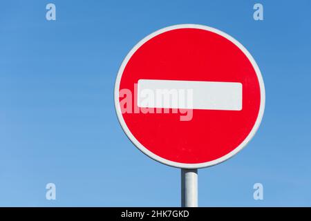 Round road stop sign, on a pole against the sky Stock Photo