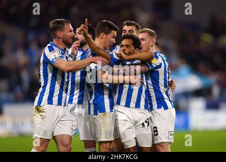 Huddersfield Town's Duane Holmes (no.19) celebrates scoring their side's first goal of the game with team-mates during the Sky Bet Championship match at The John Smith's Stadium, Huddersfield. Picture date: Wednesday February 2, 2022. Stock Photo