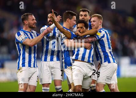 Huddersfield Town's Duane Holmes (no.19) celebrates scoring their side's first goal of the game with team-mates during the Sky Bet Championship match at The John Smith's Stadium, Huddersfield. Picture date: Wednesday February 2, 2022. Stock Photo