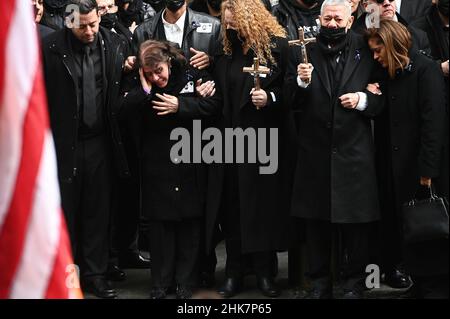 New York, USA. 02nd Feb, 2022. The mother (second from left) of fallen NYPD Officer Wilbert Mora weeps as she stands with her family outride of St. Patrick's Cathedral at the conclusion of funeral services for the slain officer, New York, NY, February 2, 2022. Thousands of NYPD officers converged on New York City's St. Patrick's Cathedral for the second time in a week to pay tribute to a fallen young officer; Mora was shot along with Officer Jason Rivera on Jan. 21 while responding to a call about a domestic argument. (Photo by Anthony Behar/Sipa USA) Credit: Sipa USA/Alamy Live News Stock Photo