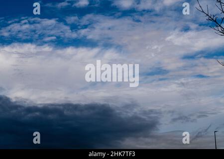 Blue sky shrouded in gray dark clouds Stock Photo