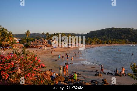 Visitors on the beach at Chacala on Mexico's Riviera Nayarit coast. Stock Photo