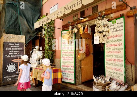 NORCIA, ITALY - JUNE 12, 2019: Cured meats, sausages and salami sold as typical local delicatessen. One the numerous typical shops selling foods in No Stock Photo