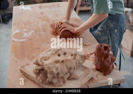 Photo of process of creating pottery by hands in workroom Stock Photo