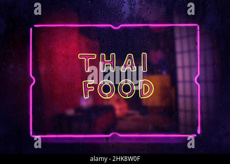 Neon Sign Thai Food in Rainy Window Stock Photo