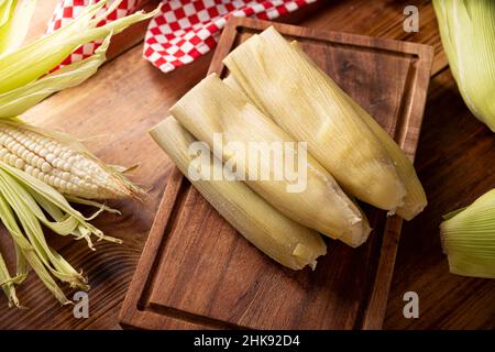 Tamales de Elote, also called Uchepos. Typical Mexican dish. Can be served  with green salsa and accompanied by sour cream or served as a dessert cover  Stock Photo - Alamy