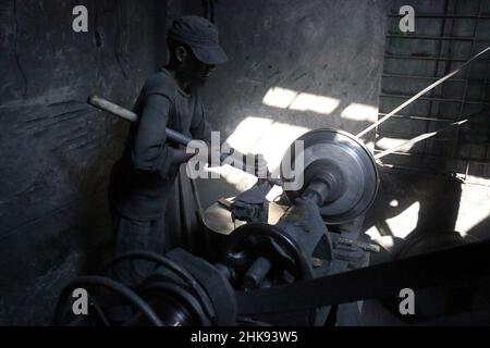 FEBRUARY 02,2022,DHAKA,BANGLADESH- Workers make utensils in an unhealthy environment at an aluminium factory in Dhaka's Kamrangirchar is home to a num Stock Photo