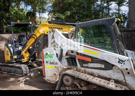 Bobcat mini excavator machine in a Sydney garden, NSW,Australia Stock Photo