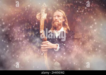 Alchemist in a beautiful ornamental dress in nature. Stock Photo