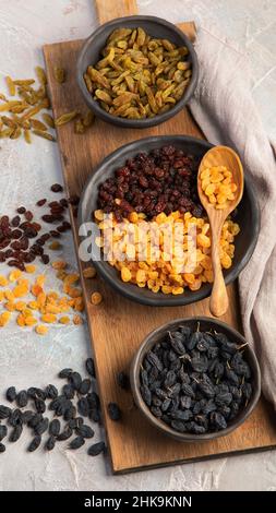 Different types of raisins on light backgroound. Dried Fruits. Top view, flat lay Stock Photo