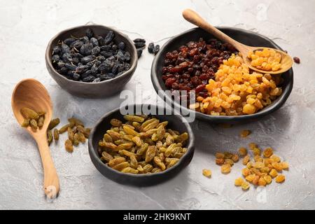 Different types of raisins on light backgroound. Dried Fruits. Stock Photo