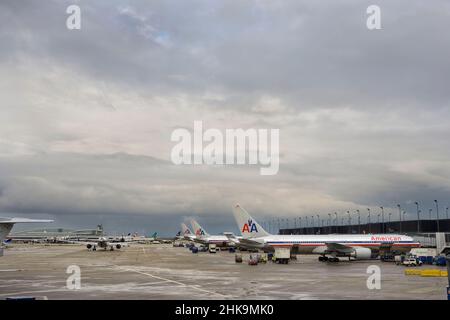 Aircrafts lined up in the distance on the tarmac after the rain Stock Photo