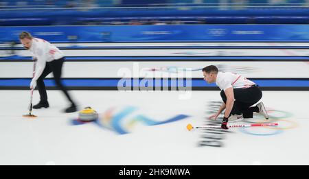 Beijing, China. 3rd Feb, 2022. John Morris (R) of Canada and his teammate Rachel Homan competes during the Beijing 2022 Winter Olympic Games between Great Britain and Canada at National Aquatics Centre in Beijing, China, Feb. 3, 2022. Credit: Zhou Mi/Xinhua/Alamy Live News Stock Photo