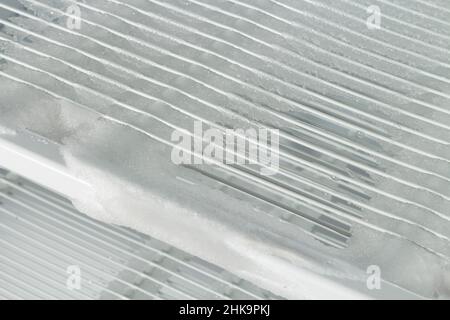 Ice in the freezer on the shelves of the refrigerator is melting and water is dripping Stock Photo