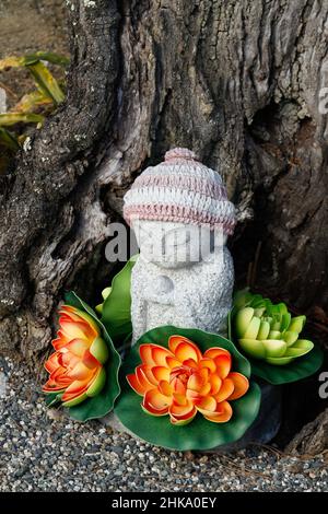 Iida, nagano, japan, 2022/03/02 , small statue with flowers at Motozenkouji Temple. It has a strong relationship with Zenkoji Temple in Nagano City, a Stock Photo