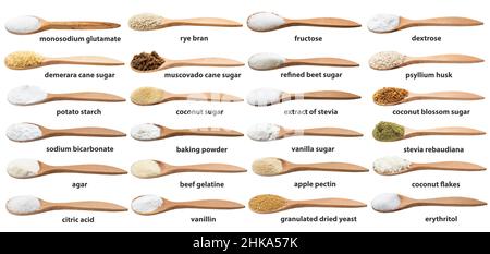 set of various cooking enhancers in wooden spoon with names isolated on white backgrouns Stock Photo