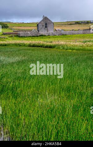 Tresta Kirk next to Papil Water on Fetlar in the Shetland Islands. Stock Photo